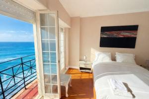 a bedroom with a bed and a view of the ocean at Atlantic Views Sintra Guest House in Colares