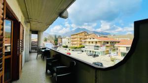 a balcony with chairs and a view of a city at La Contessa B&B Torrette in Mercogliano