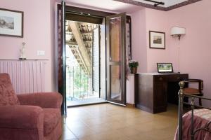 a living room with a chair and an open door at Casa del Grande Vecchio 2 in Airasca