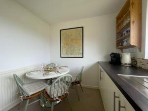 a kitchen with a table and chairs and a counter at 16 Manesty View in Keswick +10 photos