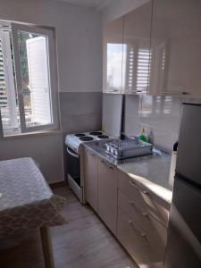 a kitchen with a stove top oven in a kitchen at Captain's villa in Molunat
