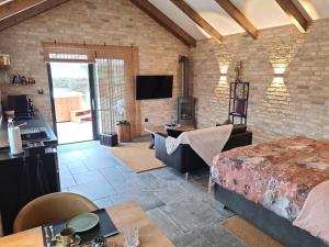 a living room with a bed and a tv at Ferienhaus Sweet-Escape in Löningen