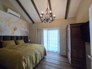 a bedroom with a bed and a chandelier at Ferienhaus Sweet-Escape in Löningen +25 photos