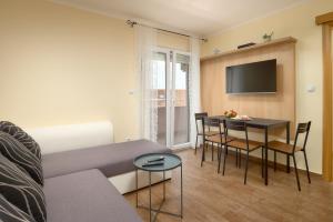 a living room with a couch and a table at APARTMANI SABB in Jezera