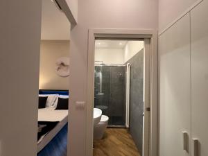 a small bathroom with a bed and a shower at MILUAR Relais - Piazza Fuga in Naples +30 photos