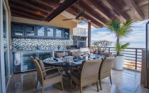 a kitchen and dining room with a table and chairs at Suites at Zona Romantica in Puerto Vallarta