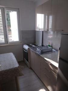 a kitchen with a stove and a counter top at Captain's villa in Molunat +49 photos