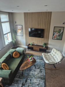 a living room with a couch and a coffee table at Sleep Eat Repeat Apartment in Macclesfield