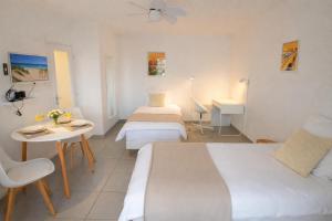 a hotel room with two beds and a table at Le Twins - Appartement de charme à Digoin in Digoin
