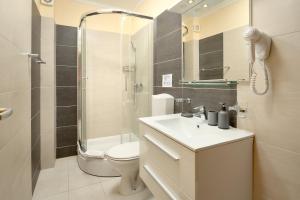 a bathroom with a toilet and a sink and a shower at APARTMANI SABB in Jezera +34 photos