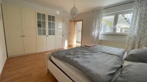 a bedroom with a bed and a large window at Ferienwohnung Karl May in Lennestadt