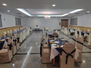 a banquet hall with blue tables and white chairs at Hotel Restaurante Peñarroya in Argamasilla de Alba