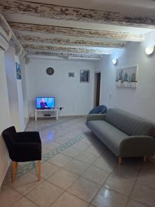 a living room with a couch and a tv at Forteca home in Perast