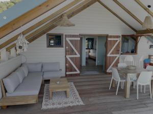 a living room with a couch and a table at Caribbean Shelter in Bouillante
