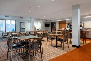 a restaurant with tables and chairs and a bar at All Seasons Resort in Kalkaska