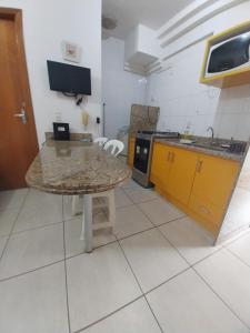 a kitchen with a table and a counter top at #Flats Studio 45 Bueno Oeste in Goiânia +20 photos