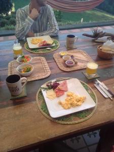 a wooden table with plates of food on it at finca la sultana in Salento +7 photos
