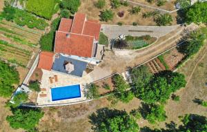 an aerial view of a house with a swimming pool at Holiday Home Pearl in Stone in Imotski