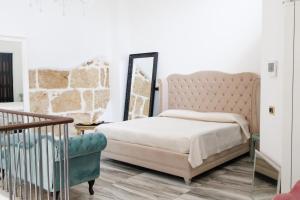 a bedroom with a bed and a mirror at Ire' Luxury Suite in Avola