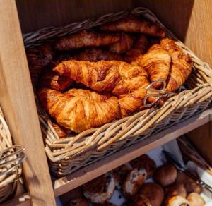 a bunch of croissants and other baked goods in a basket at Bakery Boutique Hotel in Leeuwarden