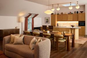 a living room and kitchen with a couch and a table at The Hoxton, Edinburgh in Edinburgh