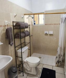 a bathroom with a toilet and a sink at Bonsai House in Ramos Arizpe +14 photos