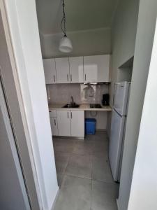 a kitchen with white cabinets and a white refrigerator at Musses Studios in Minia +83 photos