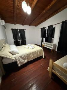 a bedroom with two beds and a television in it at Refugio del Alma in Villa Anizacate