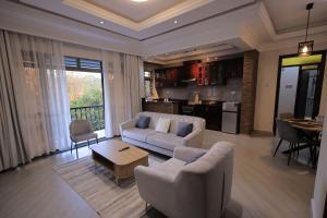 a living room with a couch and a table at Taye Apartments in Entebbe