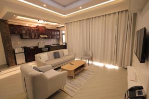 a living room with a couch and a table at Taye Apartments in Entebbe