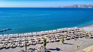 an aerial view of a beach with chairs and umbrellas at Alia Beachfront Suites and Spa in Haraki