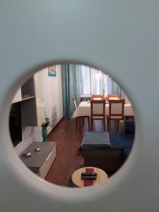 a living room with a table and a couch at Madeira Home Holidays in Caniço