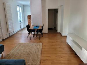 a dining room with a table and chairs in a room at Apartamenti HUGO in Valmiera