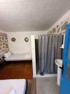 a bathroom with a shower curtain and a sink at White Scale Agroturizmo in Bar +46 photos