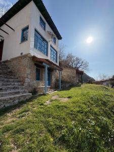 a house on top of a grassy hill at White Scale Agroturizmo in Bar