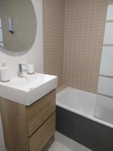 a bathroom with a sink and a bath tub at Apartamento "Playa de Sada" in Sada