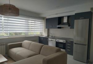 a living room with a couch in a kitchen at Apartamento "Playa de Sada" in Sada
