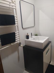 a white bathroom with a sink and a mirror at Apartamento "Playa de Sada" in Sada +42 photos