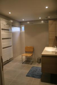 a bathroom with a chair and a sink at Chalet Jarte in Barvaux +17 photos