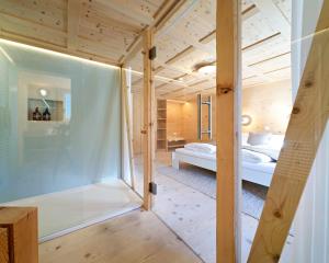a room with a glass door leading into a bedroom at Lenk Lodge - Boutique & Design Hotel und Apartements in Lenk