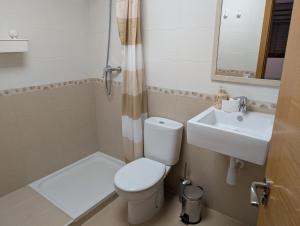 a small bathroom with a toilet and a sink at IM80 in Montroig