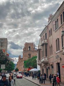 a group of people walking down a city street at Cossy studio apartment in downtown in Cuenca