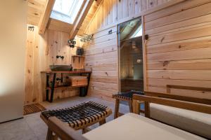 a room with wooden walls and a bench and a table at Apartments Rožič Bohinj in Bohinj