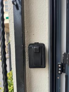 a black door handle on the side of a building at White Apartment in Baku