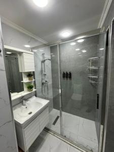 a bathroom with a shower and a sink at White Apartment in Baku +28 photos