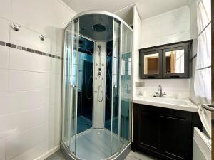 a glass shower in a bathroom with a sink at Le Petit Vallon in Polleur +26 photos