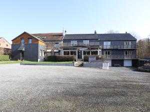 a large house with a driveway in front of it at Le Petit Vallon in Polleur