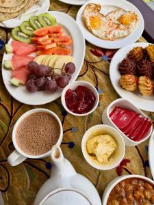 a table with plates of food and bowls of dips at Weather cottage in Srinagar