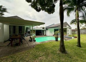 a house with a swimming pool in a yard at Turtle Sands Holiday Home in Richards Bay
