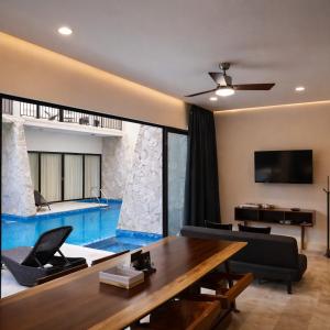 a living room with a swimming pool in a house at NEW 2 bed swim-up, gril with jacuzzi Aldea Zamá in Tulum